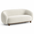 Divano curvo in tessuto boucl¨¦ crema con gambe in legno
